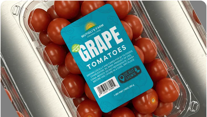 a plastic container of grape tomatoes with a large printed label on it