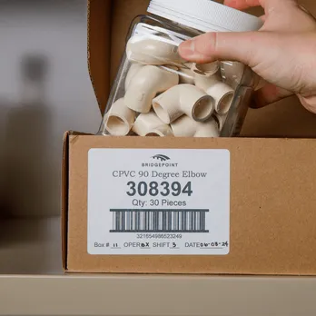 Cardboard box with white barcode label containing product number
