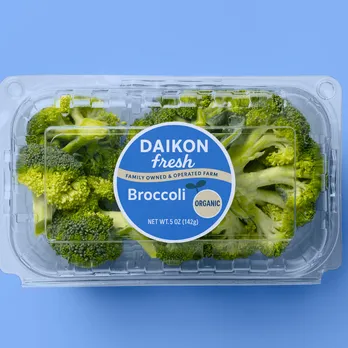 Fresh broccoli in container with blue digitally printed produce label