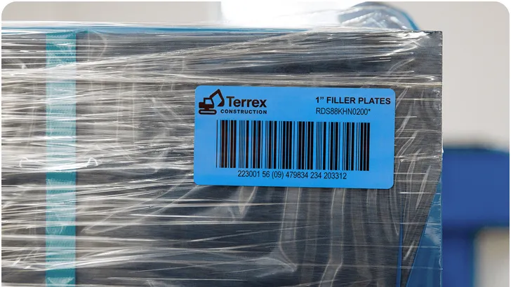 a shrinkwrapped pallet of boxes with a large blue sequential label