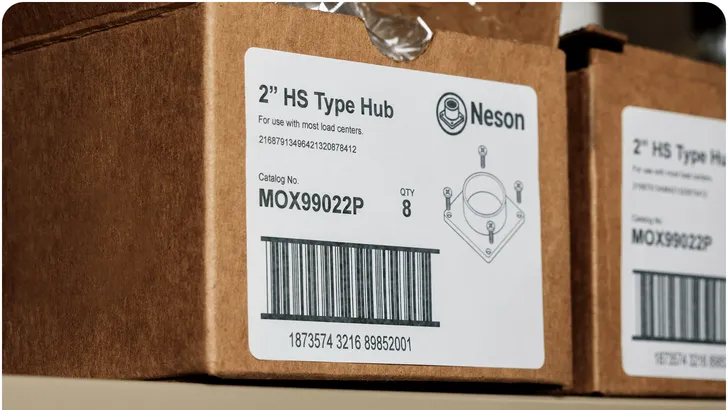 two cardboard boxes sitting next to eachother with the same printed thermal label on the side of them