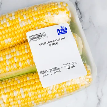 Fresh corn package with white custom thermal label showing product information