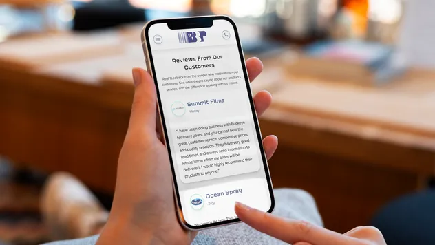 A person holding a smartphone in their hands and scrolling down the screen