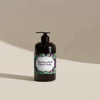 Black hand soap bottle with decorative botanical label