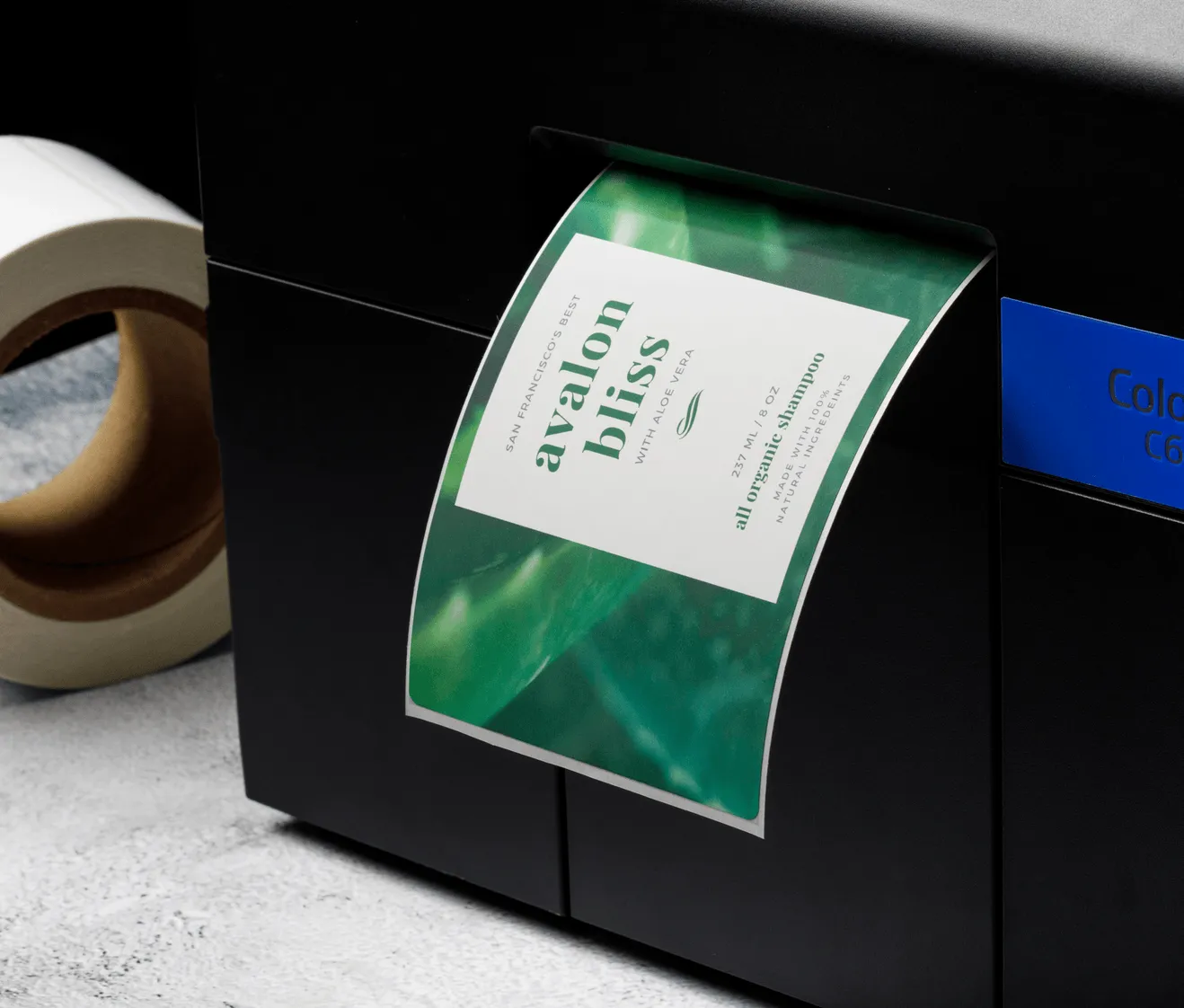 desktop inkjet printer with colorful label sheet and roll of white labels