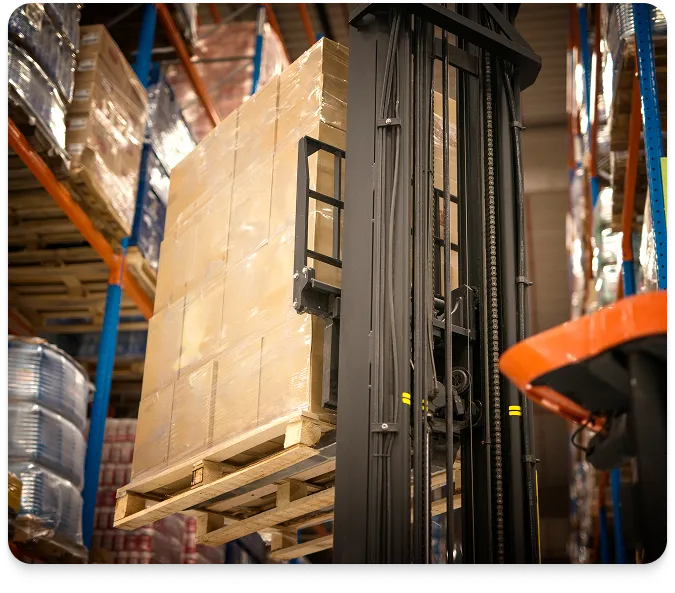 a forklift raising a pallet of boxes high above warehouse shelves 