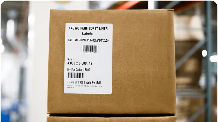 stacked cardboard boxes with thermal barcode labels