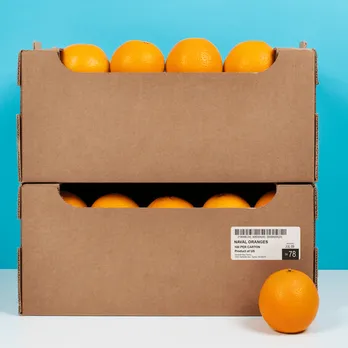 Orange shipping crate with fresh oranges and barcode label
