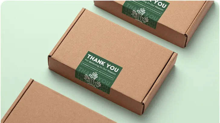 three rectangular cardboard boxes with green labels