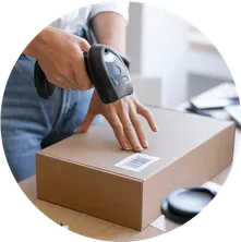 someone using a hand scanner on a labeled cardboard box