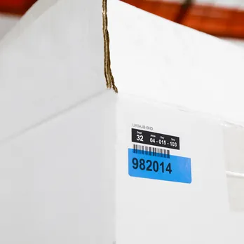 White PVC pipe with blue adhesive label showing product information