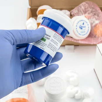 Hand holding specimen tube with medical label