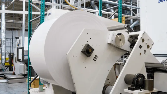 Large rolls of paper material in a warehouse for label manufacturing