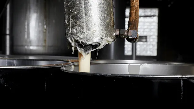 Close-up of adhesive coating equipment with label material
