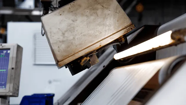 Laminating machine combining facestock, adhesive, and liner layers