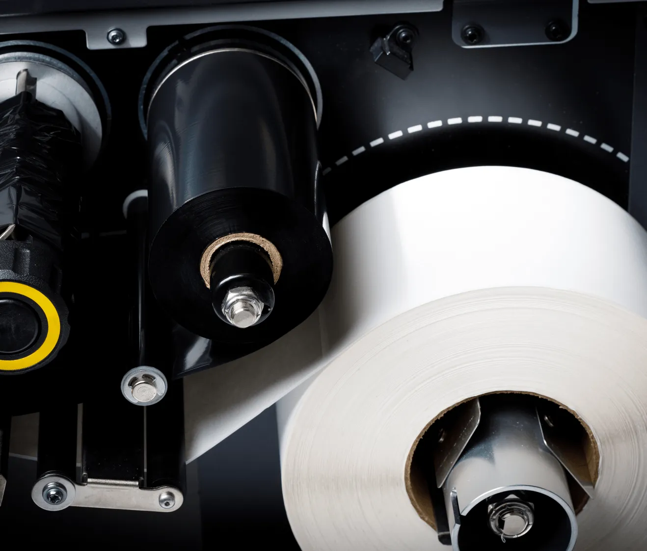 close-up view of thermal transfer printer mechanism showing ribbon and white label roll