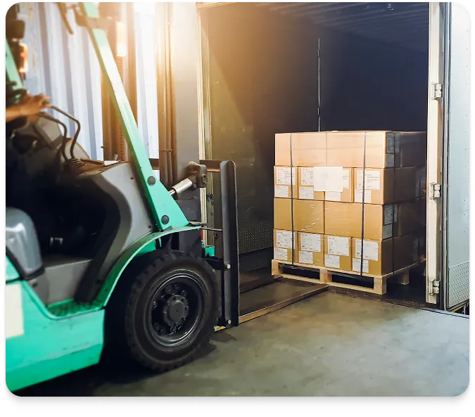 A forklift transferring a pallet of boxes from a truck