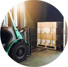 a fork lift in front of a pallet of boxes